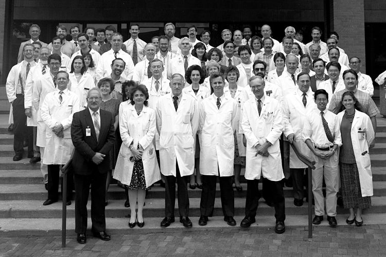 Dr. Jeffrey Myers stands with Dr. Peter Ward in the front of the 1993 Faculty Group Photo.